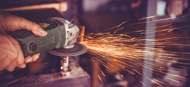A man operating an angle grinder. 