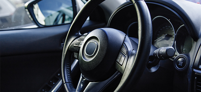 A steering wheel inside a car. 