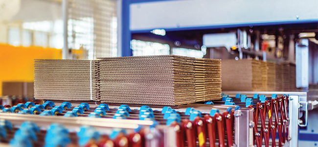 A piece of corrugated cardboard moves down the production line. 