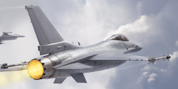 A Military F-15 plane flies under clear conditions.