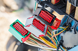 Three connectors attached to wires. 