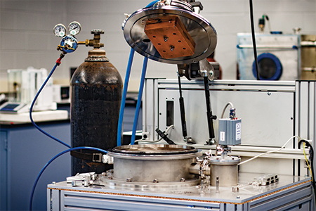 A high vacuum test rig that performs vacuum stability and outgassing testing using the ASTM E-595 test method. 