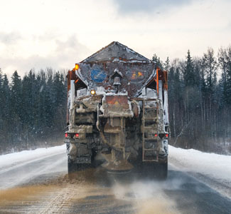 A truck sprays road salt during winter. 