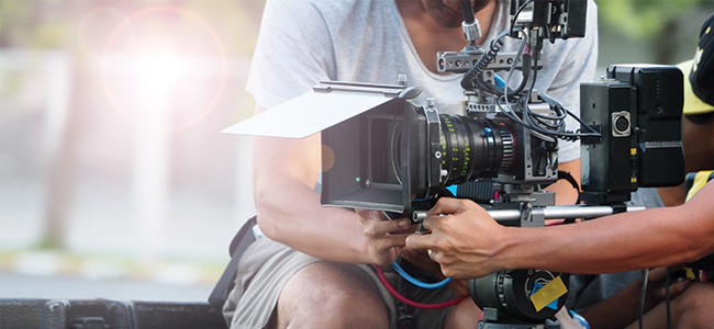 Two camera operators using a mechanical rig. 